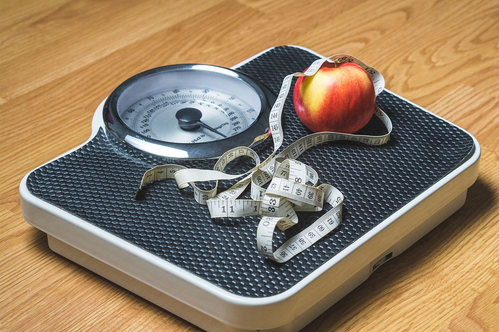 Free measuring tape and an apple on a weighing scale, public domain diet and fitness CC0 photo.