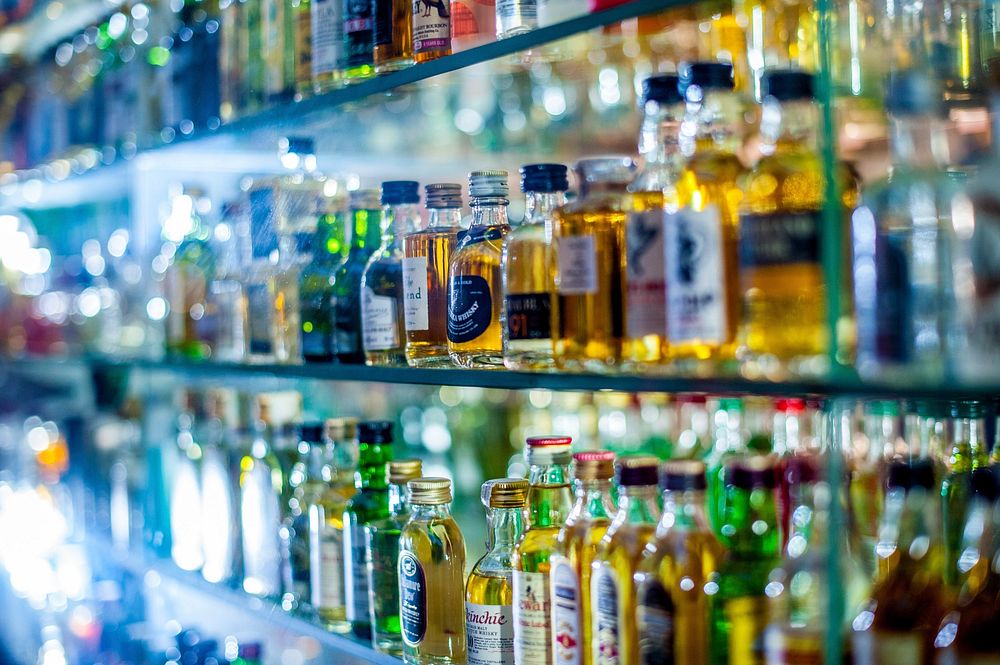 Bar counter with bottles. Free public domain CC0 photo.