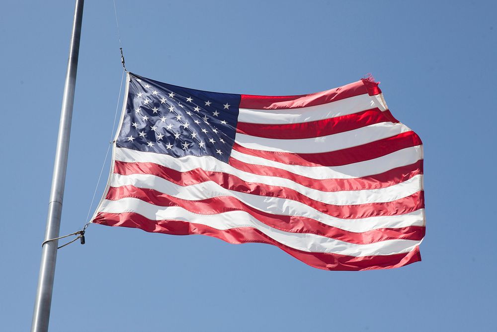 American flag waving against sky. Free public domain CC0 photo.