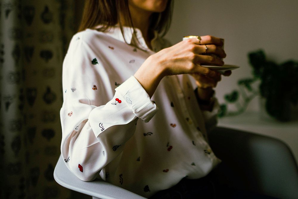 Free women with white shirt sitting in the room image, public domain people CC0 photo.