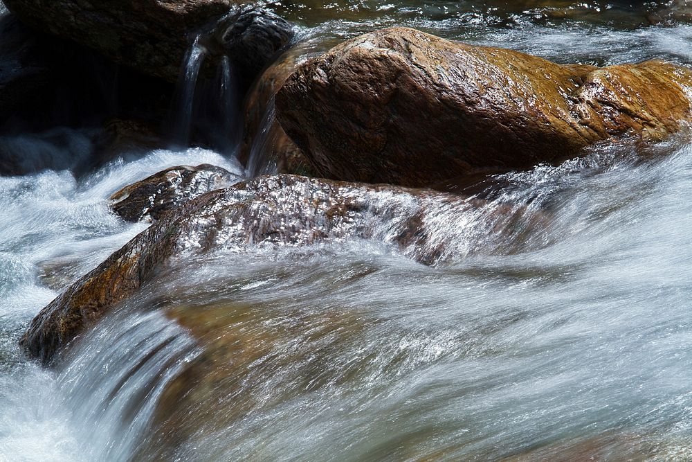 Water flowing down rocks closeup. Free public domain CC0 image.