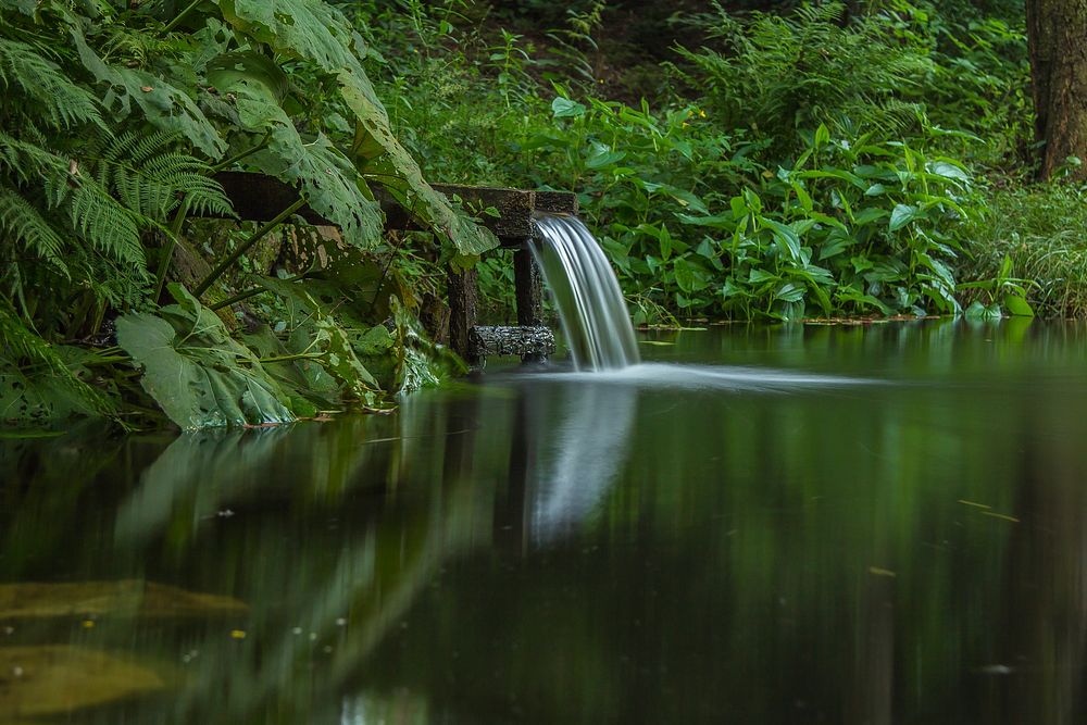 Water flowing from a pipe. Free public domain CC0 image.