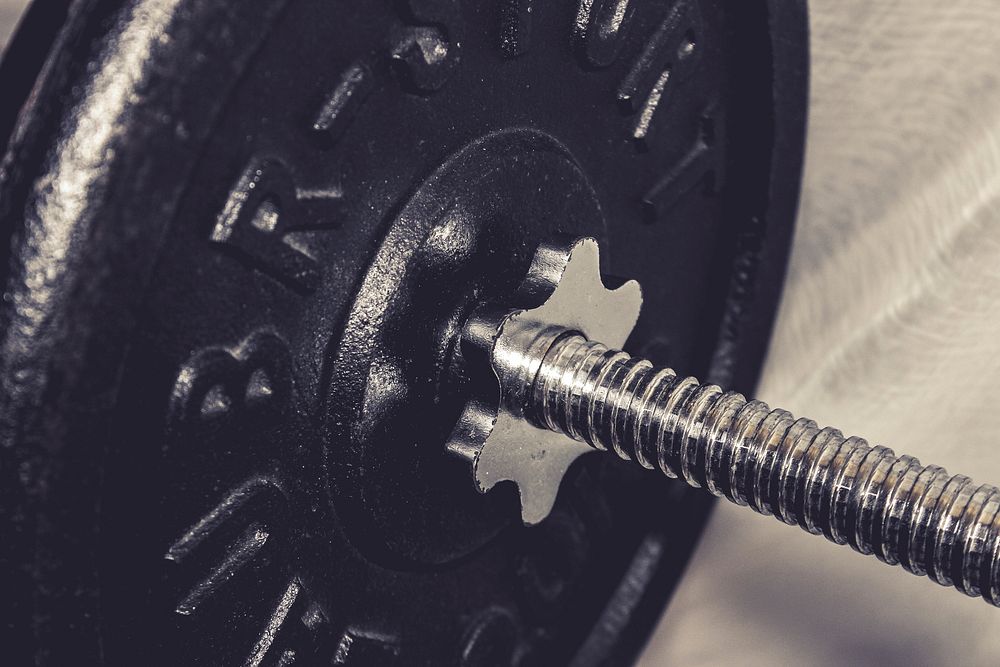 Closeup on weight plate on bar. Free public domain CC0 image.