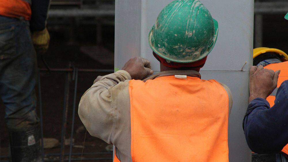 Builder at work on construction site. Free public domain CC0 photo.