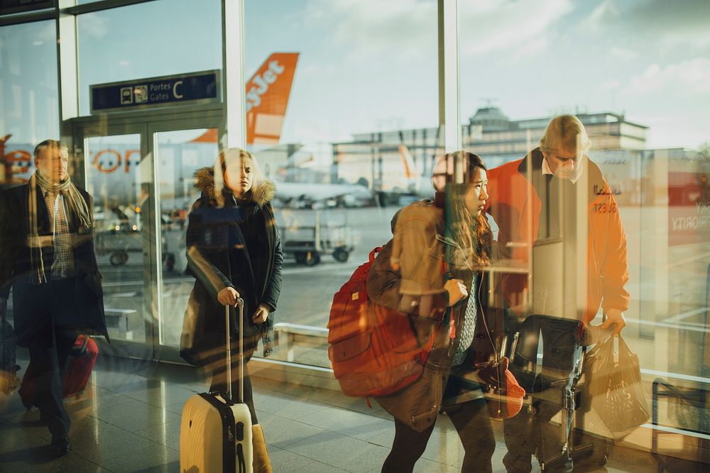 Travelers at an airport, location unknown, date unknown