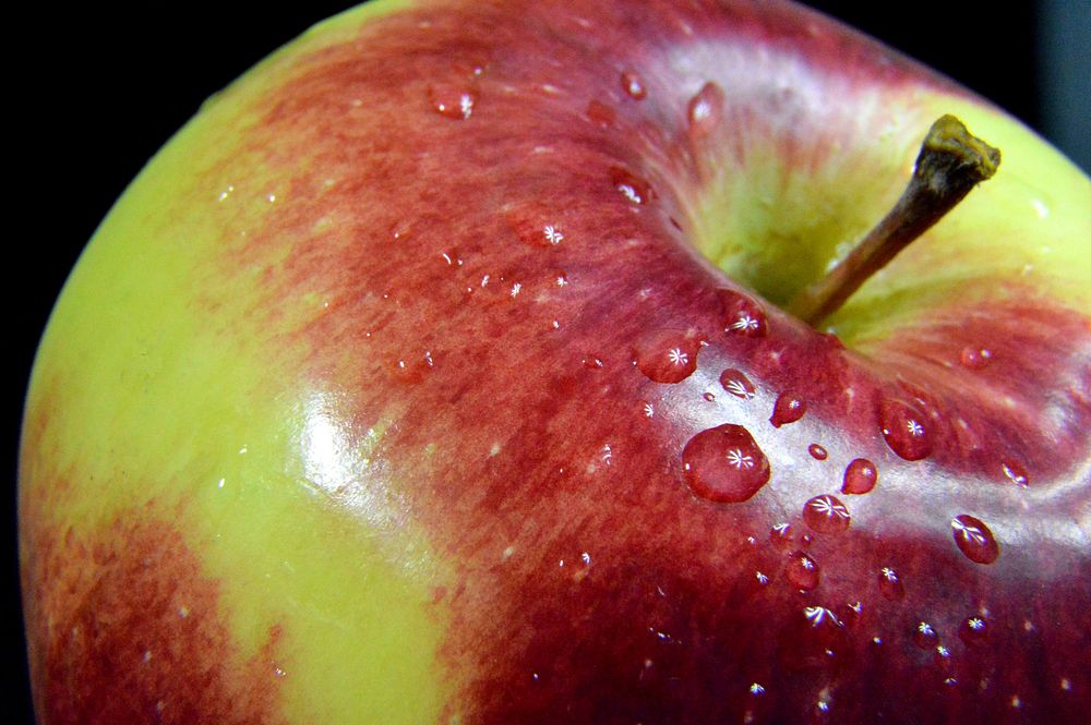 Closeup on red apple on black background. Free public domain CC0 photo.