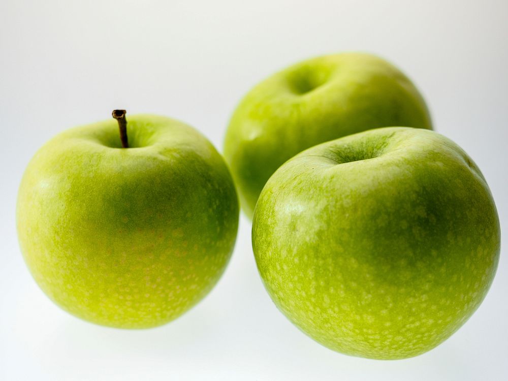 Closeup on green apples on white background. Free public domain CC0 photo.