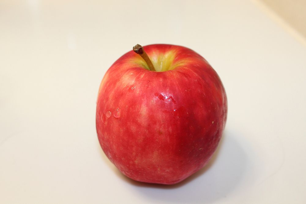 Closeup on red apple on white background. Free public domain CC0 photo.