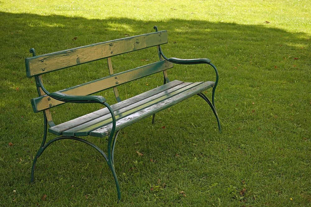 Wooden bench on a grass field. Free public domain CC0 photo.