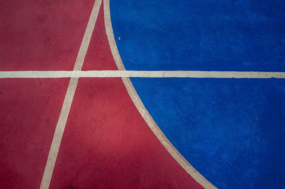 Closeup of red and blue basketball court. Free public domain CC0 image.