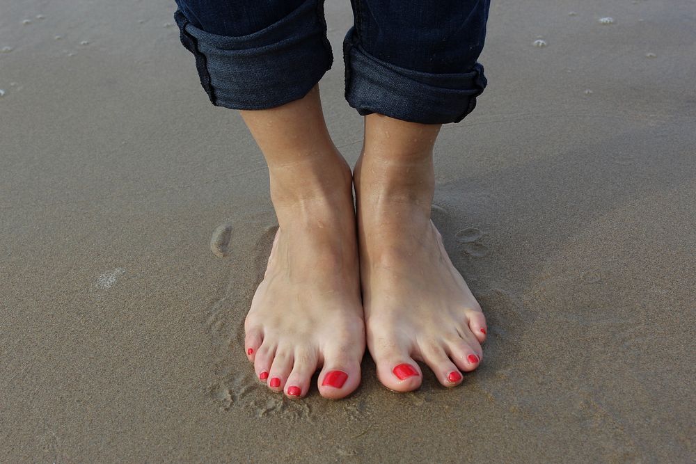 Feet in the sand. Free public domain CC0 photo.