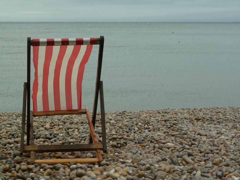 Empty white stripe beach chair. Free public domain CC0 photo.