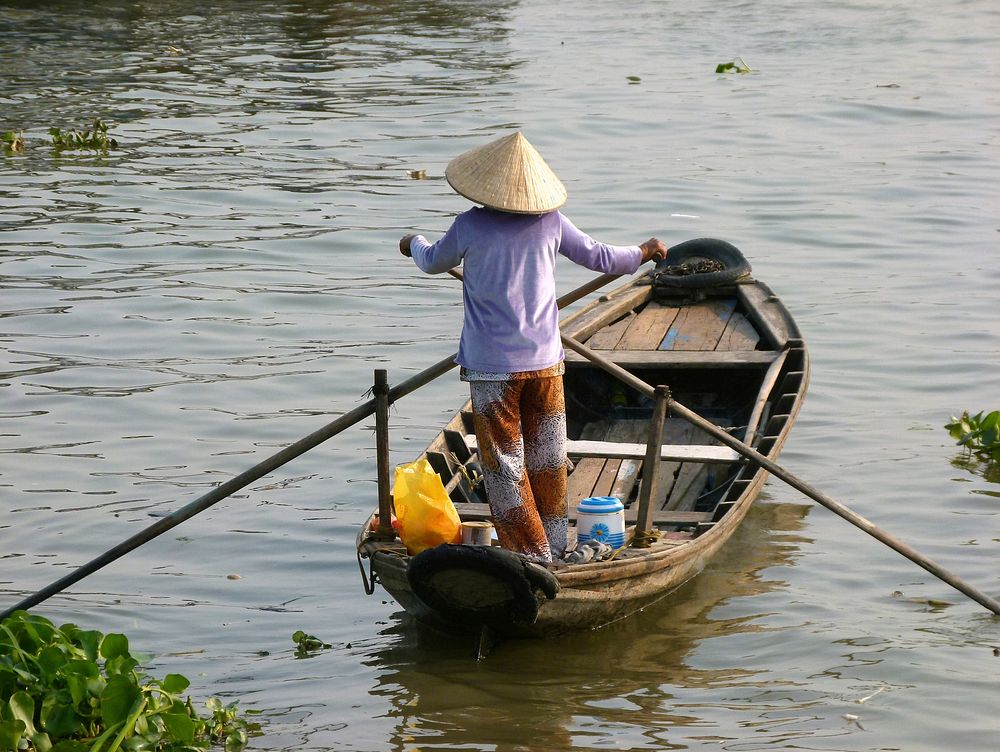 Local woman travel by canoe. Free public domain CC0 photo.