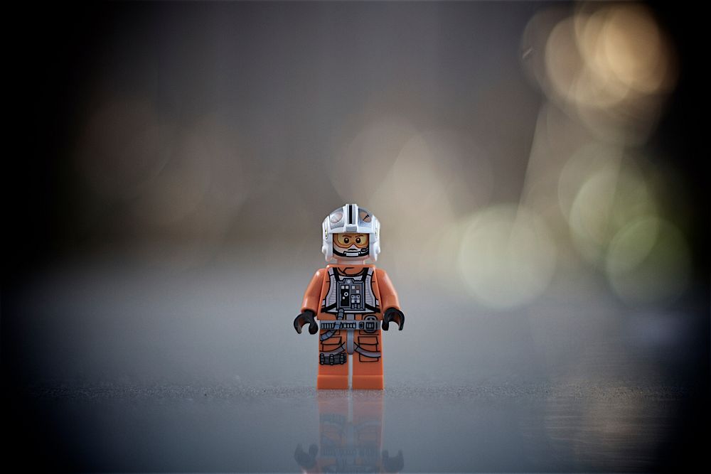 Lego doll with bokeh lights image. Free public domain CC0 photo.