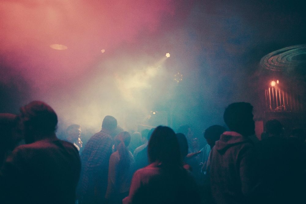 A foggy dance club with colourful lights