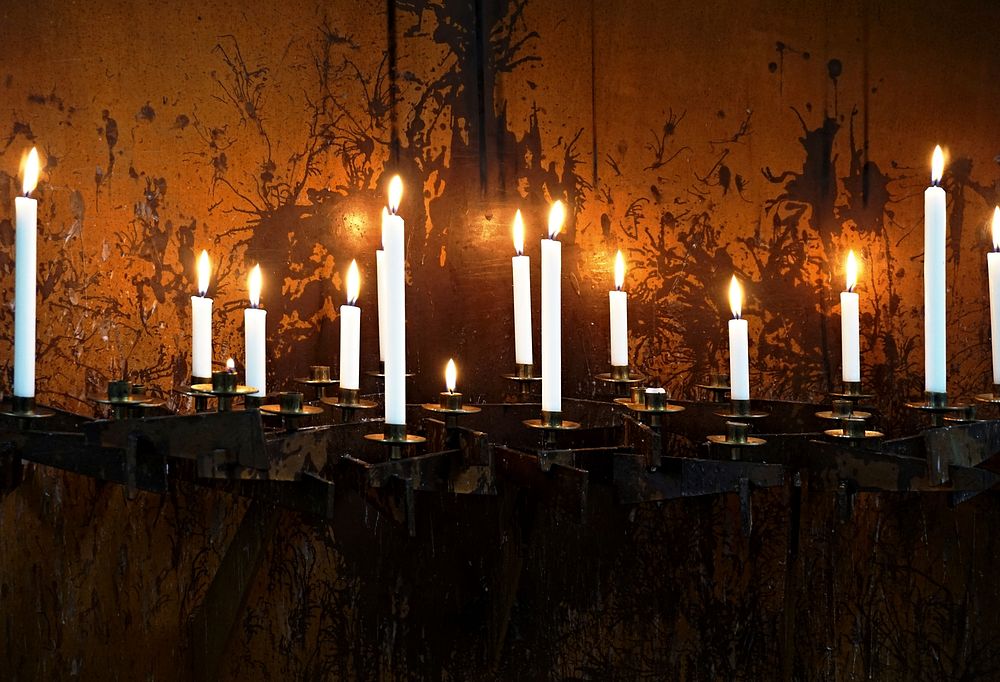 Lit candles, background photo. Free public domain CC0 image.