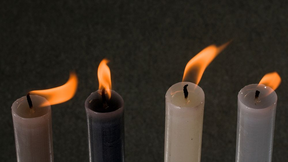 Burning candle in the dark. Free public domain CC0 image.