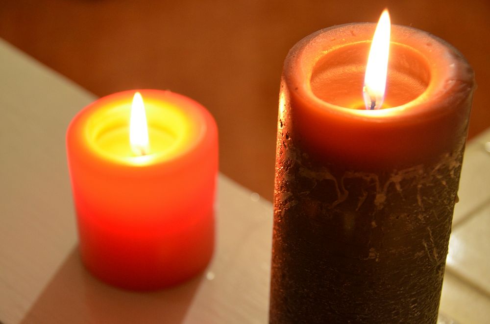 Lit candles, background photo. Free public domain CC0 image.