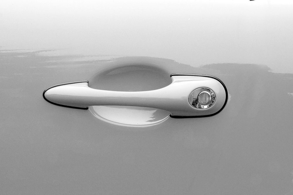 White car door handle. Free public domain CC0 photo.