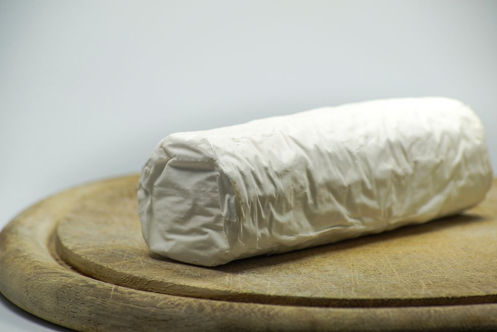 Closeup on goat cheese on cutting board. Free public domain CC0 photo.