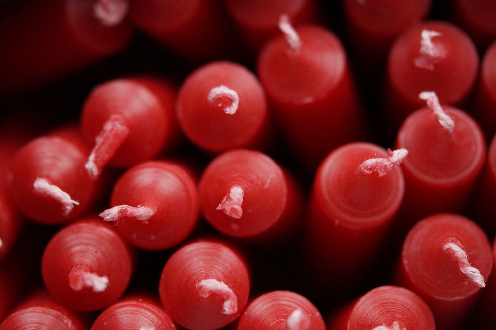 Closeup on pile of red candles. Free public domain CC0 photo.