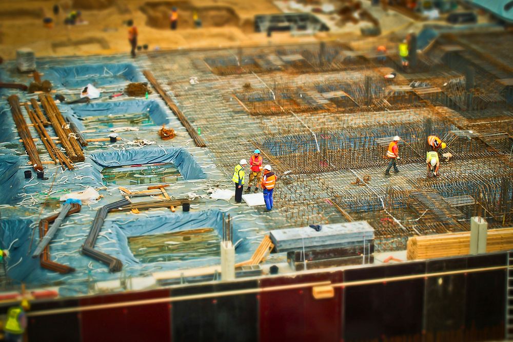 Builders at construction site. Free public domain CC0 photo.