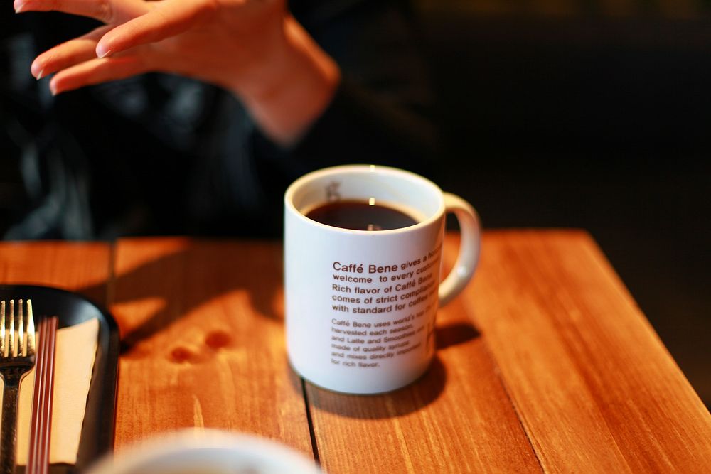 Coffee cup on table. Free public domain CC0 photo.