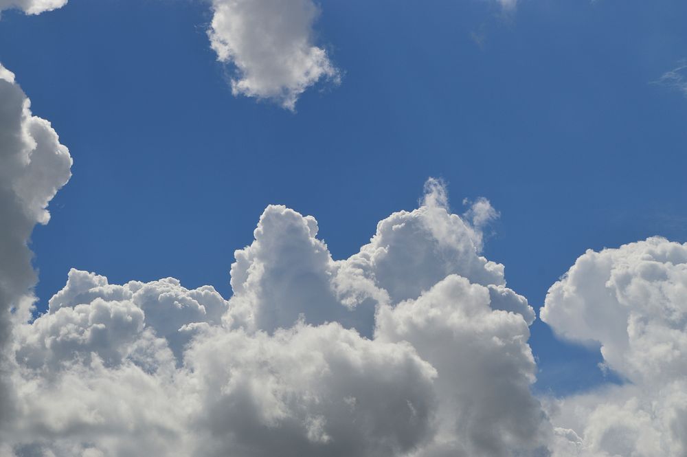 Blue sky background with clouds. Free public domain CC0 image.