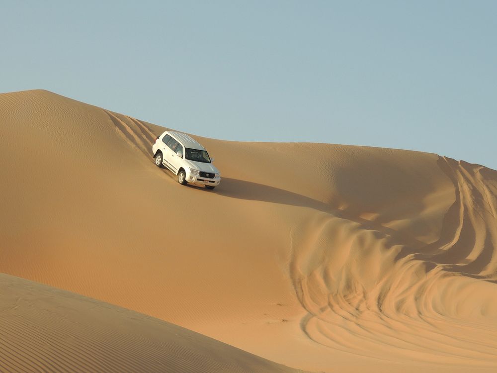 Car driven through sand dune. Free public domain CC0 photo.