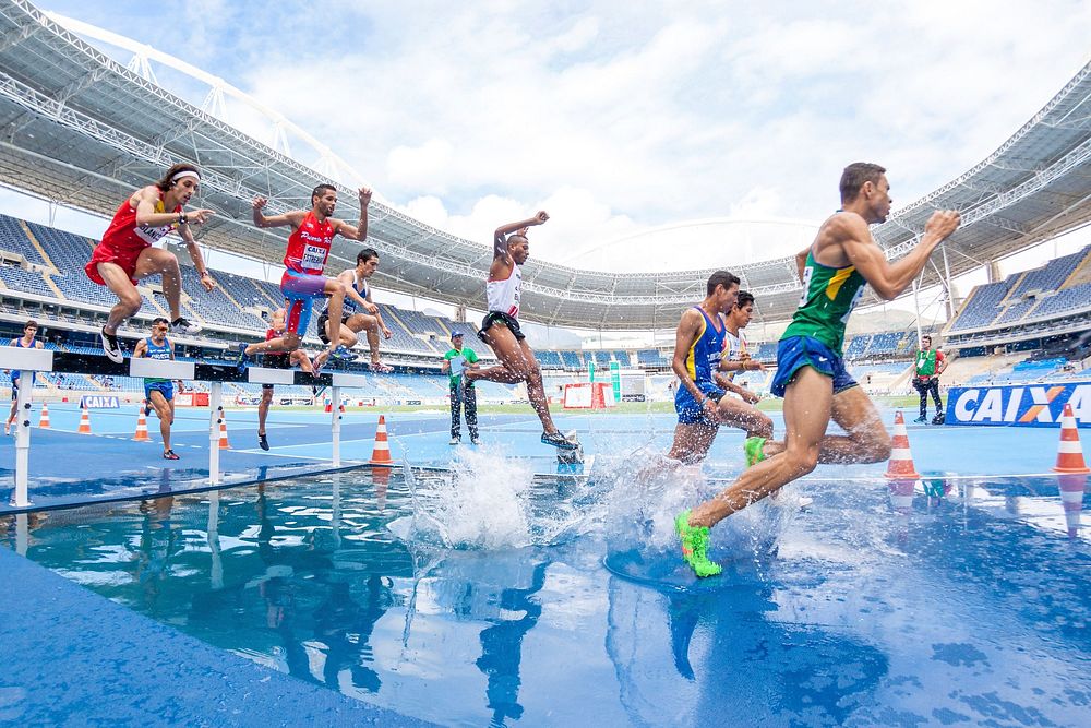 Athlete runners jump over the water obstacle in the Steeplechase final, location unknown, date unknown. View public domain…