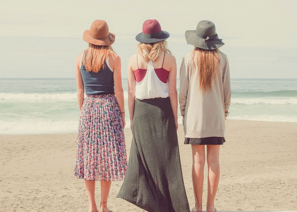 Free female friends standing on the beach public domain CC0 photo.
