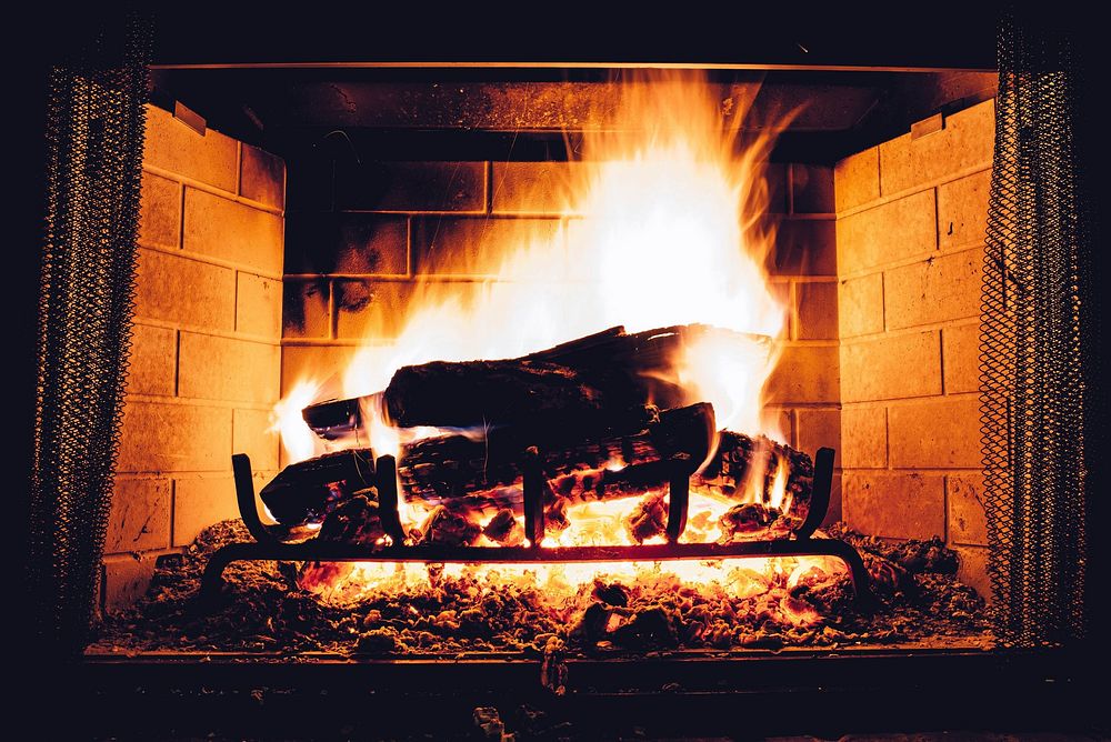 Burning log in a fireplace. Free public domain CC0 photo.