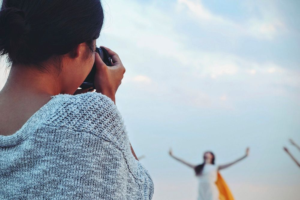 Woman photographer with dancer in the blur background