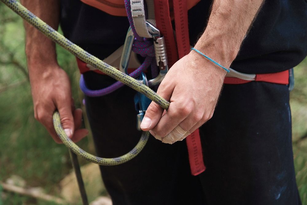 Rock climber with safety harness. Free public domain CC0 photo.
