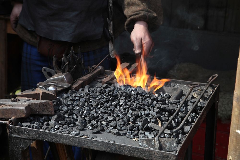 Blacksmith in workshop. Free public domain CC0 photo.