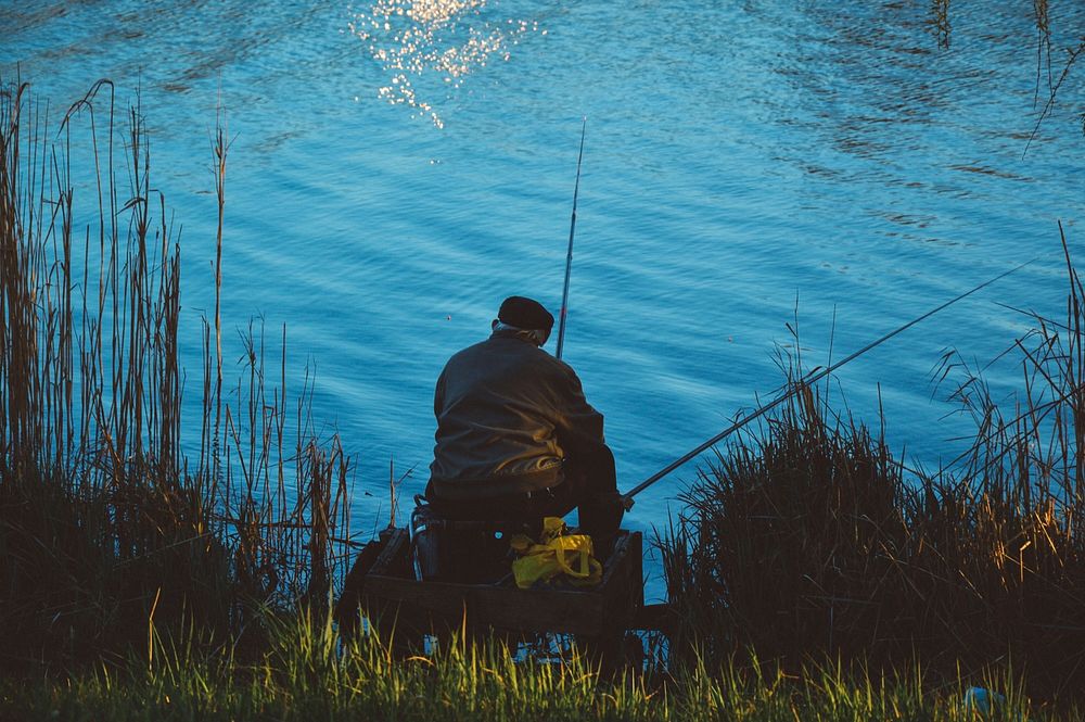 Person fishing outdoors in nature. Free public domain CC0 photo.