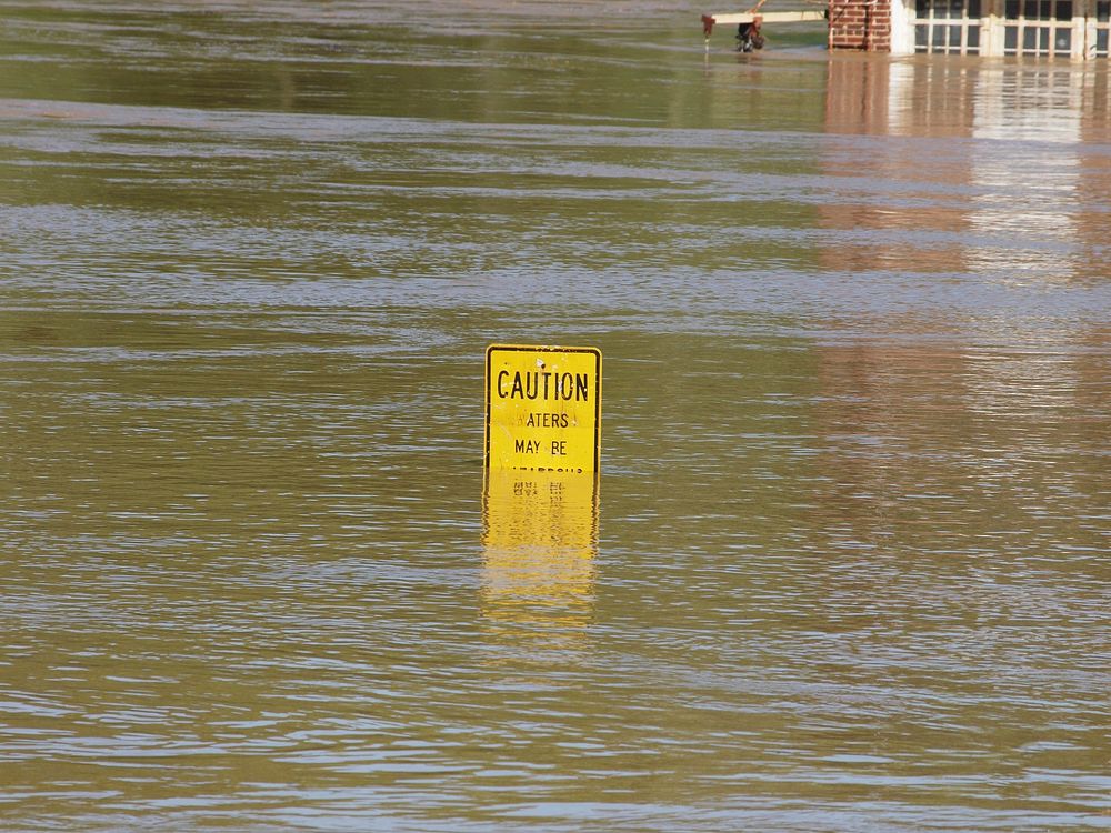 Caution sign in flood. Free public domain CC0 image.