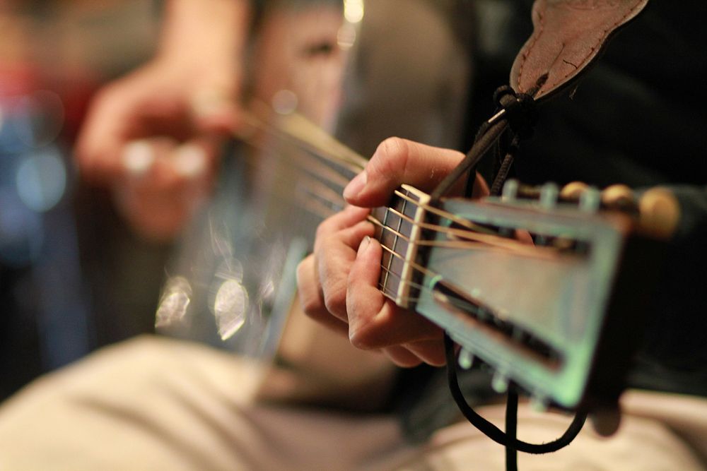 Musician playing guitar, music background.Free public domain CC0 photo.