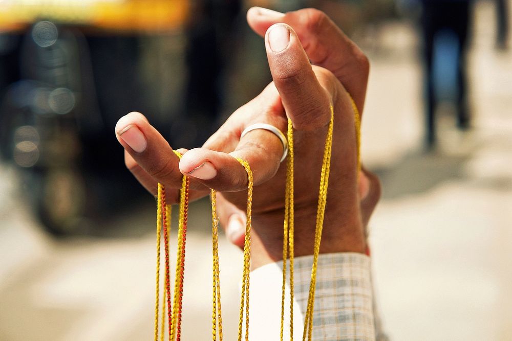 Hand holding strings close up. Free public domain CC0 photo.