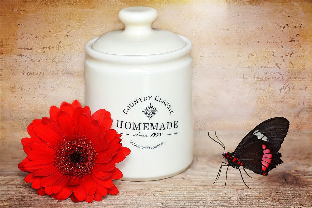 White jar with butterfly and flower. Free public domain CC0 photo.