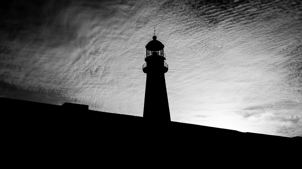 Lighthouse in black and white. Free public domain CC0 image.