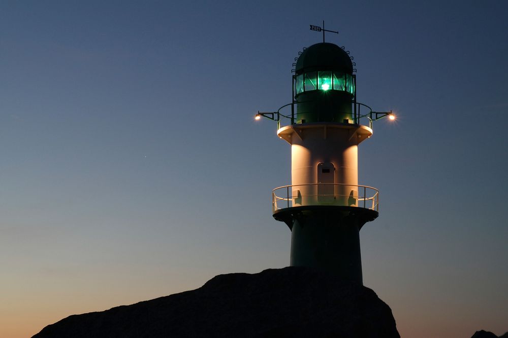 Closeup on a lighthouse during night time. Free public domain CC0 photo.