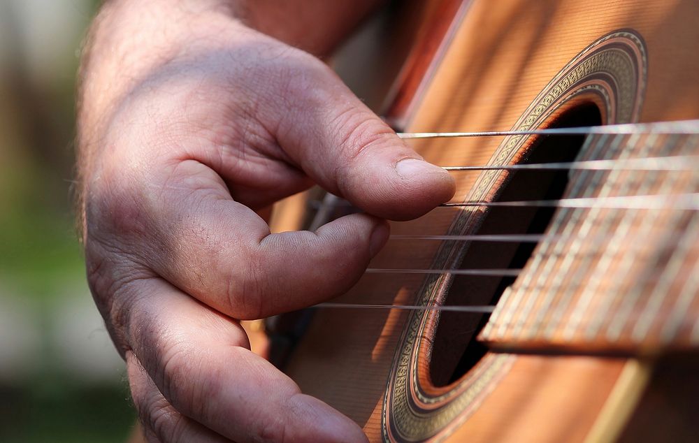 Musician playing guitar, music background.Free public domain CC0 photo.