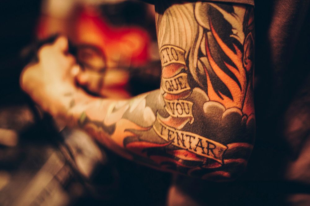Free tattoos on a man's arm public domain CC0 photo.