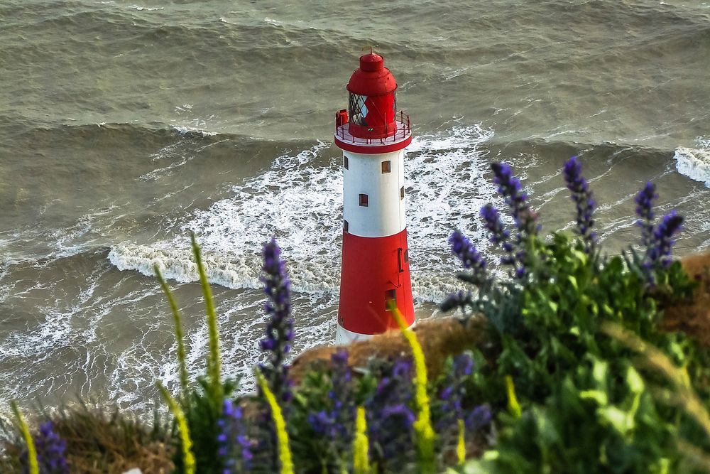 Lighthouse by a sea. Free public domain CC0 photo.
