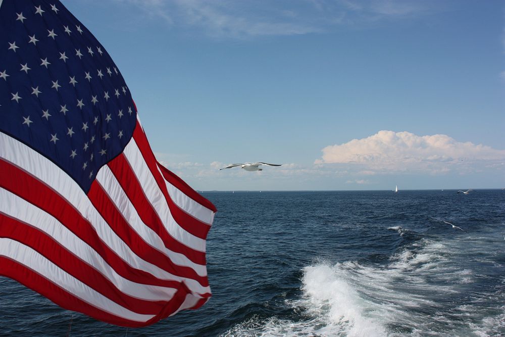 American flag, blue sky. Free public domain CC0 photo.