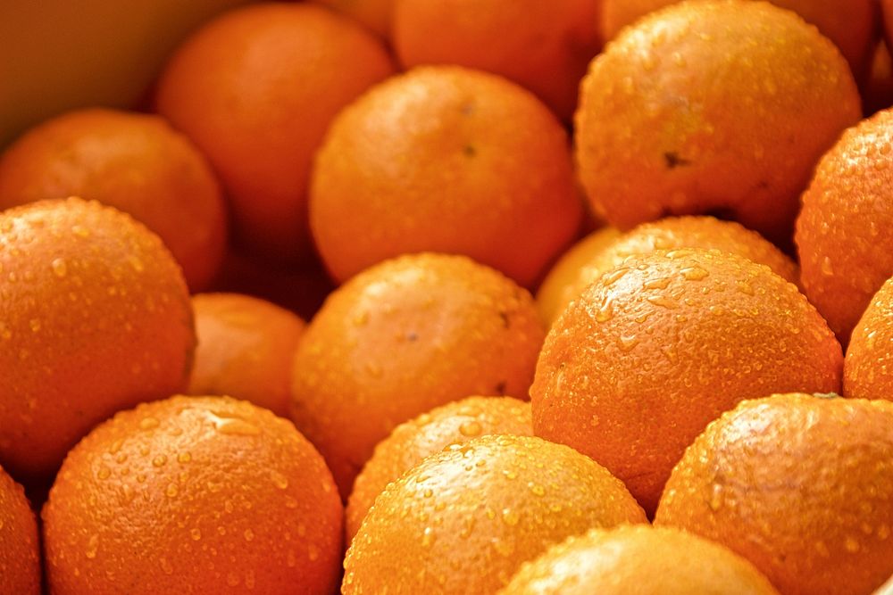 Closeup on pile of fresh oranges. Free public domain CC0 photo.