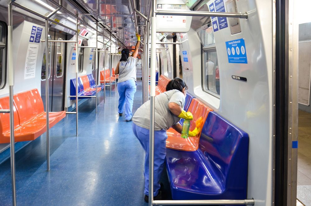Free people cleaning train seat image, public domain human CC0 photo.