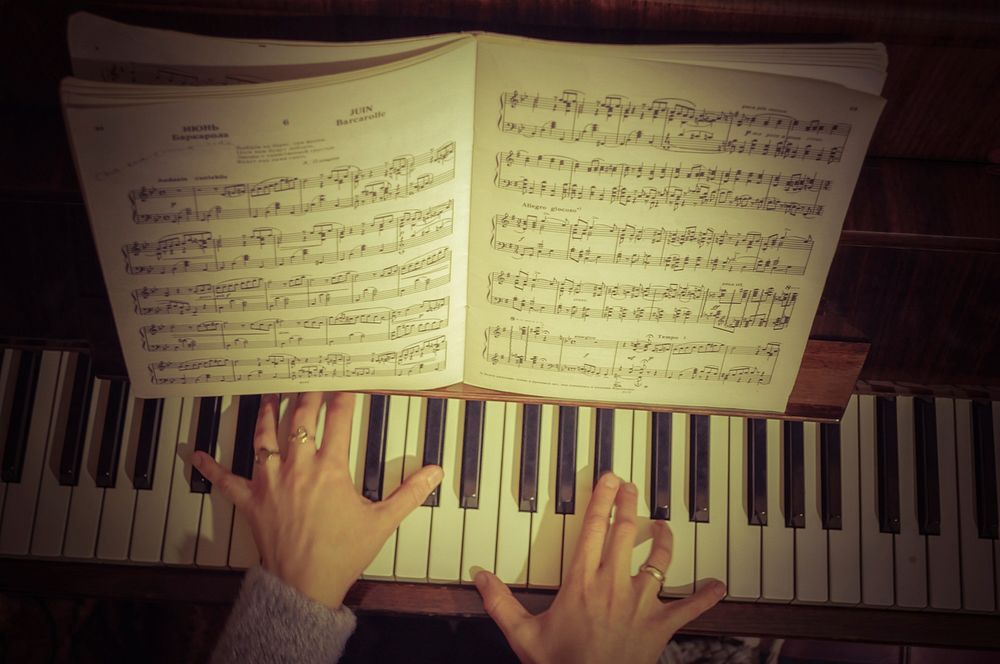 Woman playing the piano. Free public domain CC0 photo.