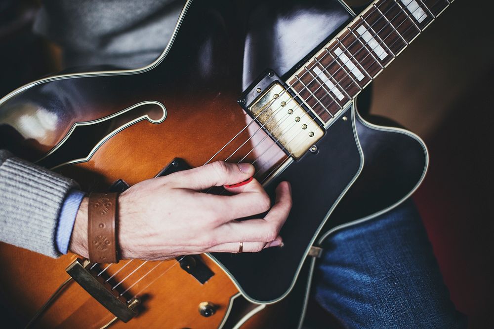 Musician playing guitar, music background.Free public domain CC0 photo.